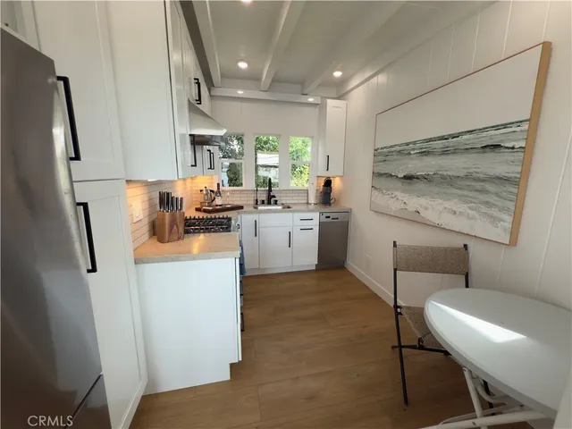 a kitchen with sink cabinets and refrigerator