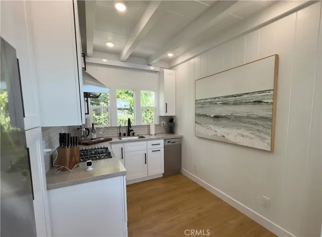 a kitchen with a stove a sink and a refrigerator