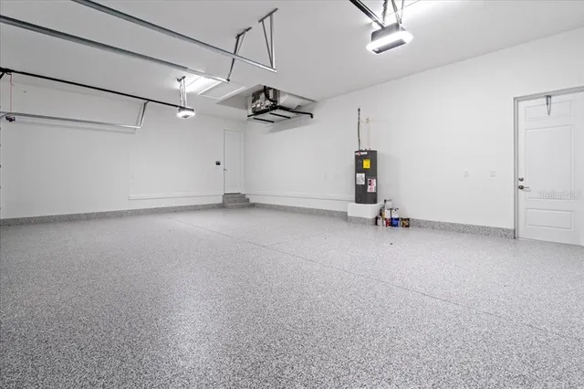 an empty room with ceiling fan and wooden floor