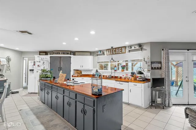 a kitchen with stainless steel appliances a sink cabinets and wooden floor