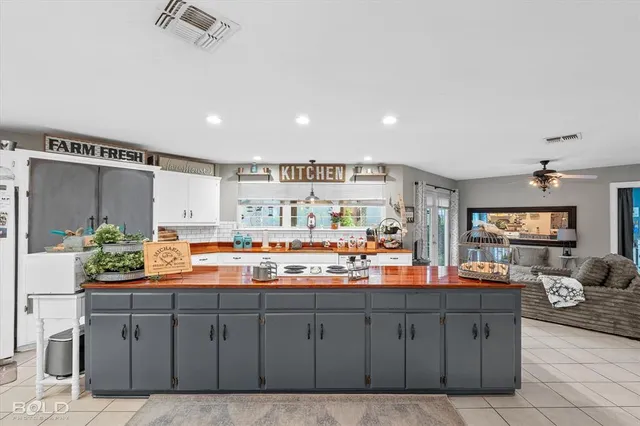 a kitchen that has a lot of cabinets in it and appliances