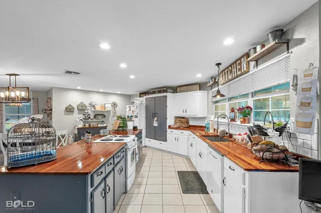 a large white kitchen with lots of counter top space
