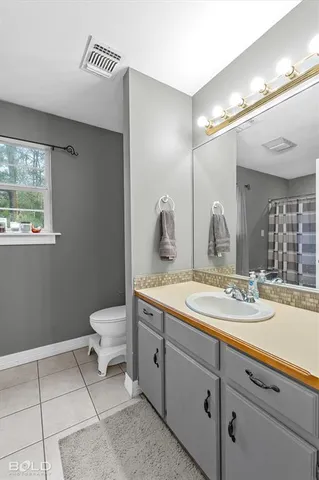 a spacious bathroom with a double vanity sink a mirror and shower