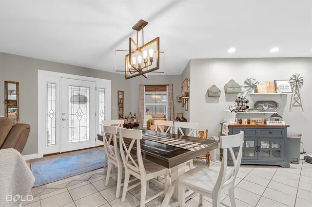 a view of a dining room with furniture wooden floor and chandelier