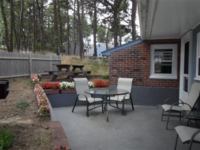 15 Massasoit Road, Unit 2 Wellfleet, MA 02667 - Photo 2 of 11 a backyard of a house with table and chairs