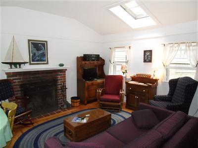 15 Massasoit Road, Unit 2 Wellfleet, MA 02667 - Photo 3 of 11 a room with furniture and a fireplace