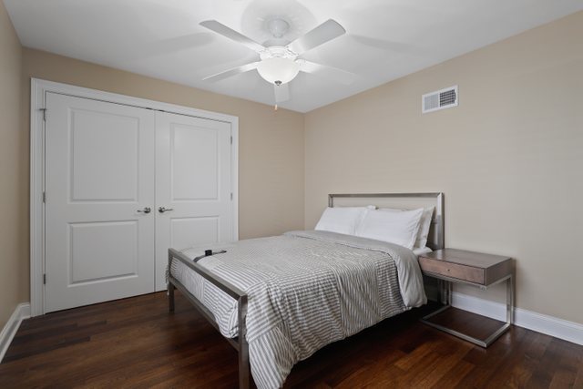934 Spring Road Elmhurst, IL 60126 - Photo 11 of 27 a bedroom with a bed and a chandelier