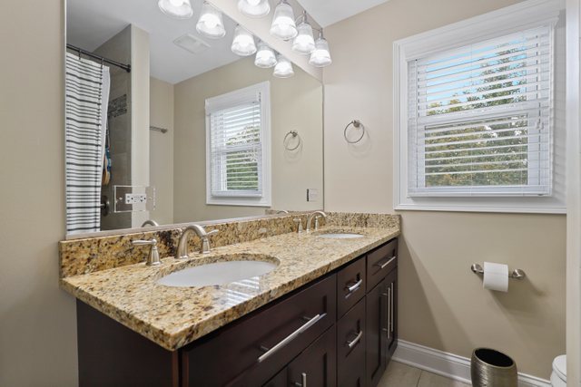934 Spring Road Elmhurst, IL 60126 - Photo 19 of 27 a bathroom with a granite countertop sink a large mirror and a shower