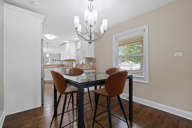 934 Spring Road Elmhurst, IL 60126 - Photo 4 of 27 a view of a dining room with furniture window and wooden floor