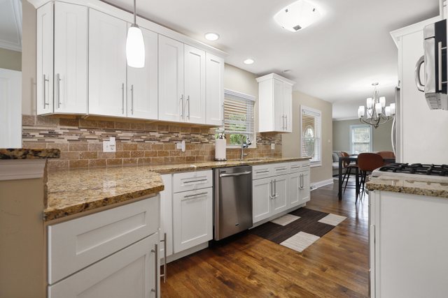 934 Spring Road Elmhurst, IL 60126 - Photo 6 of 27 a kitchen with a sink stove and cabinets