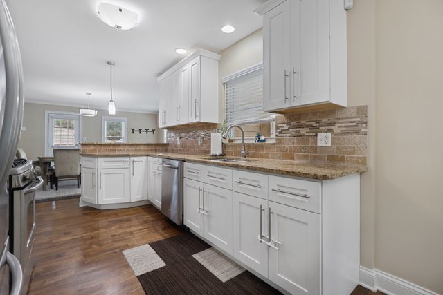 934 Spring Road Elmhurst, IL 60126 - Photo 7 of 27 a kitchen with granite countertop white cabinets and white appliances