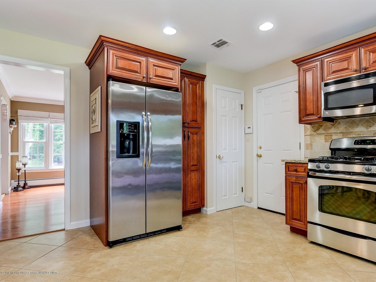 16 Canvasback Road Manalapan, NJ 07726 - Photo 12 of 26 a kitchen with stainless steel appliances granite countertop a refrigerator and a stove top oven