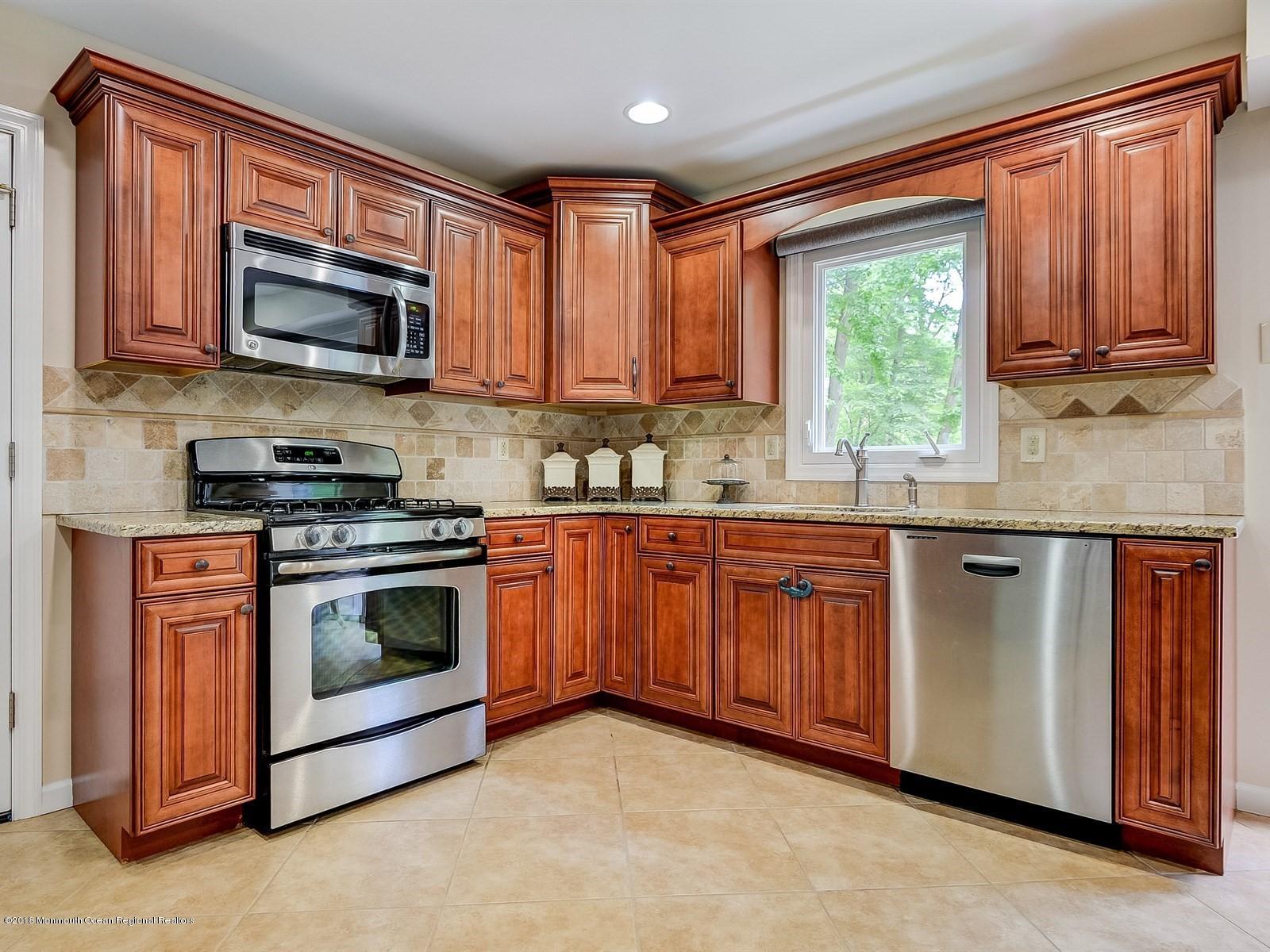 16 Canvasback Road Manalapan, NJ 07726 - Photo 13 of 26 a kitchen with stainless steel appliances granite countertop a stove sink microwave and window