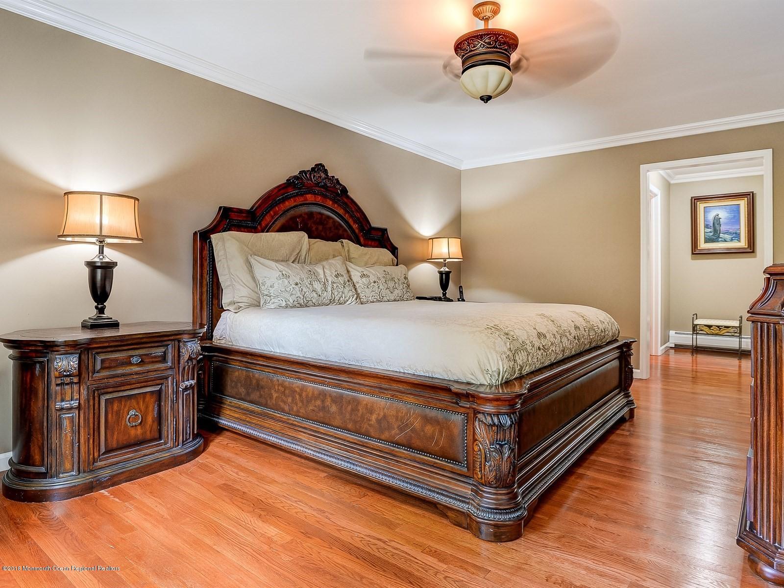 16 Canvasback Road Manalapan, NJ 07726 - Photo 15 of 26 a bedroom with a bed and wooden floor