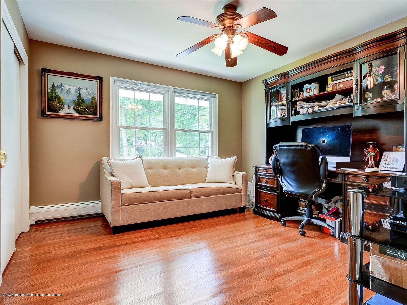 16 Canvasback Road Manalapan, NJ 07726 - Photo 20 of 26 a living room with furniture and a flat screen tv