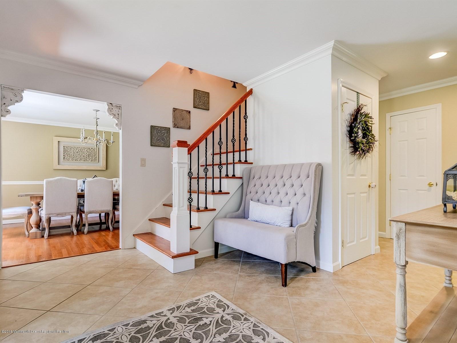 16 Canvasback Road Manalapan, NJ 07726 - Photo 2 of 26 a living room with furniture and a dining table with rug