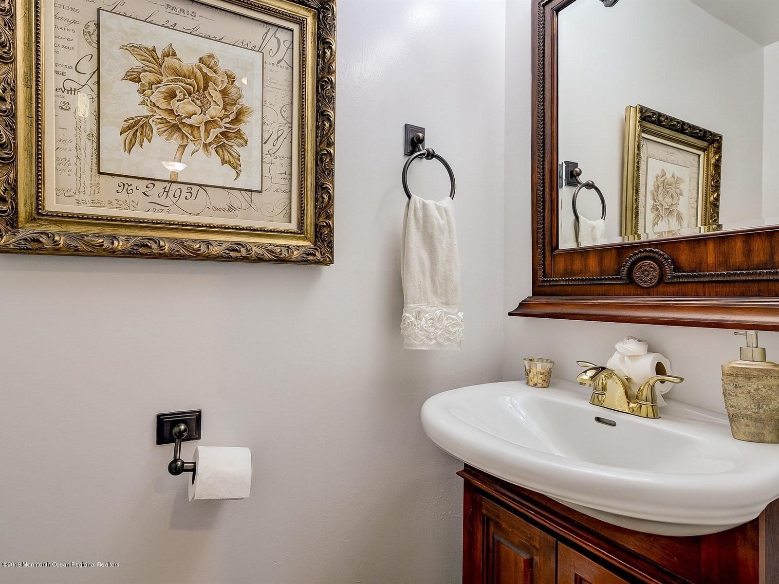 16 Canvasback Road Manalapan, NJ 07726 - Photo 22 of 26 a bathroom with a sink and a mirror