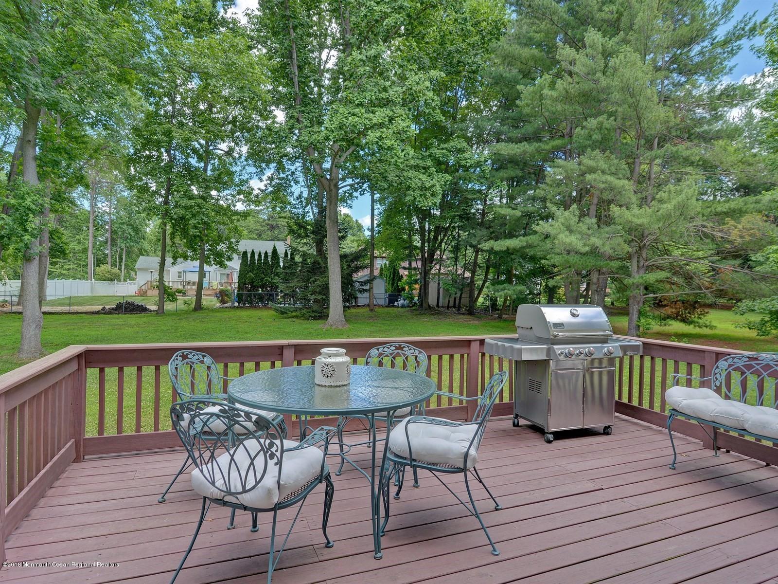 16 Canvasback Road Manalapan, NJ 07726 - Photo 23 of 26 a view of house with seating space and yard