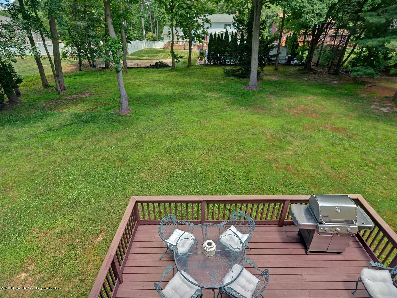 16 Canvasback Road Manalapan, NJ 07726 - Photo 24 of 26 a view of a wooden deck and a backyard