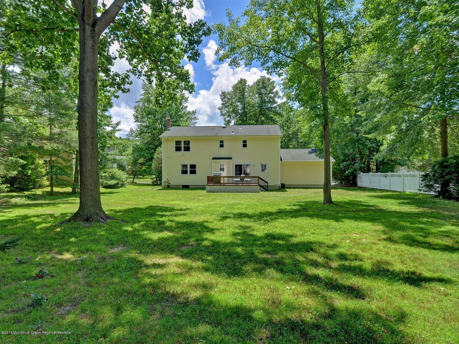 16 Canvasback Road Manalapan, NJ 07726 - Photo 25 of 26 a view of a white house with a big yard and large trees