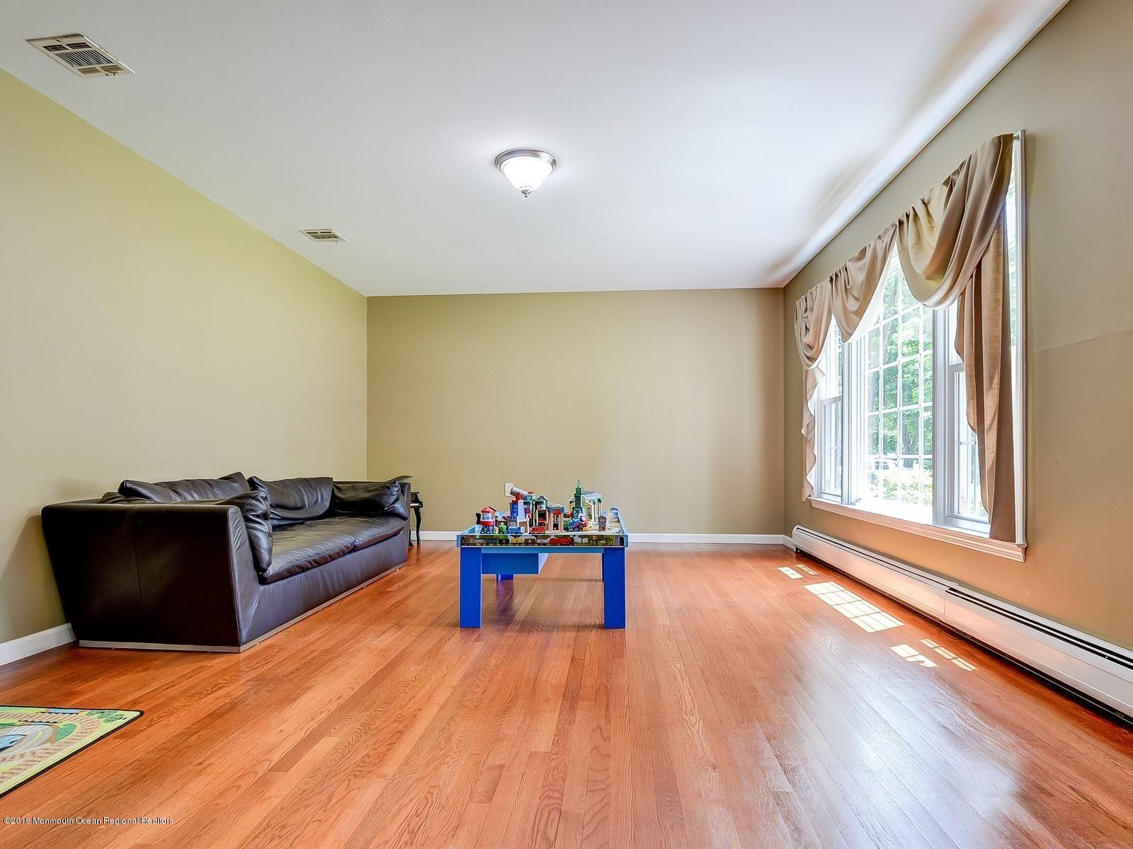 16 Canvasback Road Manalapan, NJ 07726 - Photo 5 of 26 a living room with furniture and wooden floor