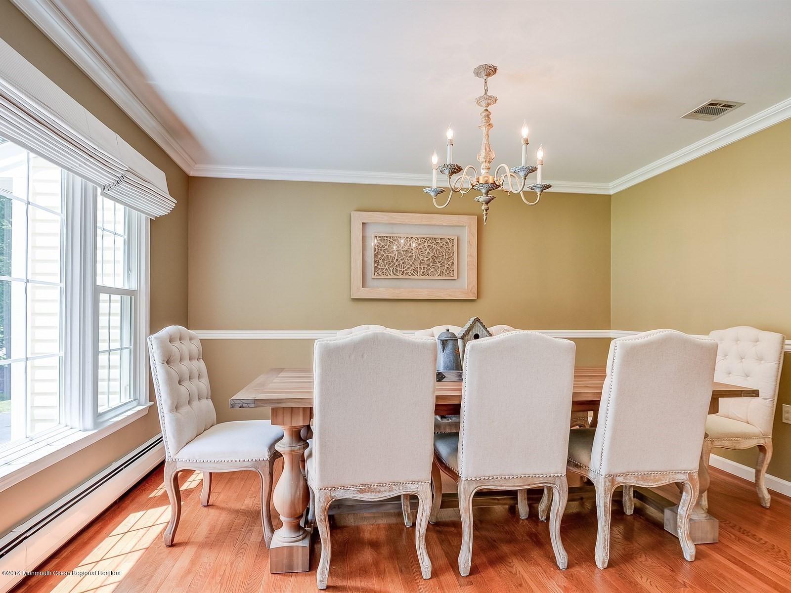 16 Canvasback Road Manalapan, NJ 07726 - Photo 6 of 26 a view of a dining room with furniture wooden floor and chandelier