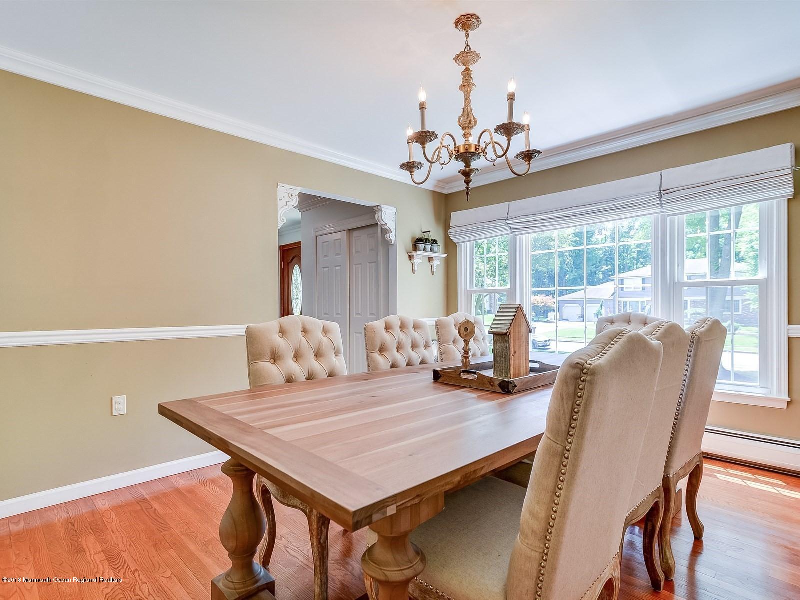 16 Canvasback Road Manalapan, NJ 07726 - Photo 7 of 26 a view of a dining room with furniture window and wooden floor