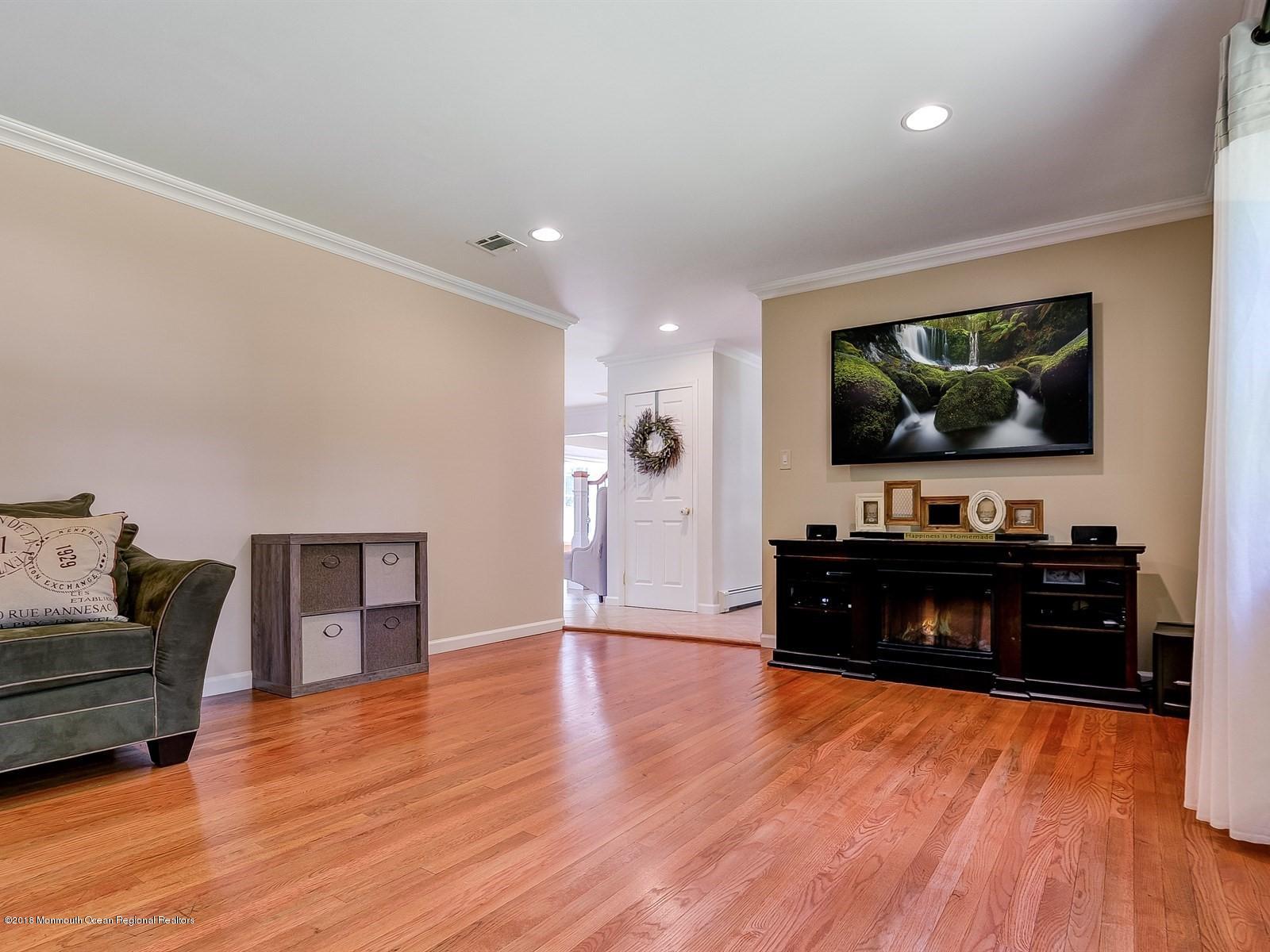16 Canvasback Road Manalapan, NJ 07726 - Photo 9 of 26 a living room with furniture and a flat screen tv