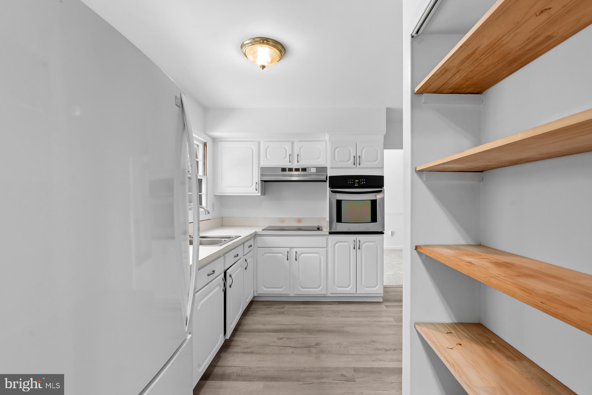 12202 Rustic Hill Drive Bowie, MD 20715 - Photo 13 of 34 a kitchen with stainless steel appliances granite countertop a sink and cabinets
