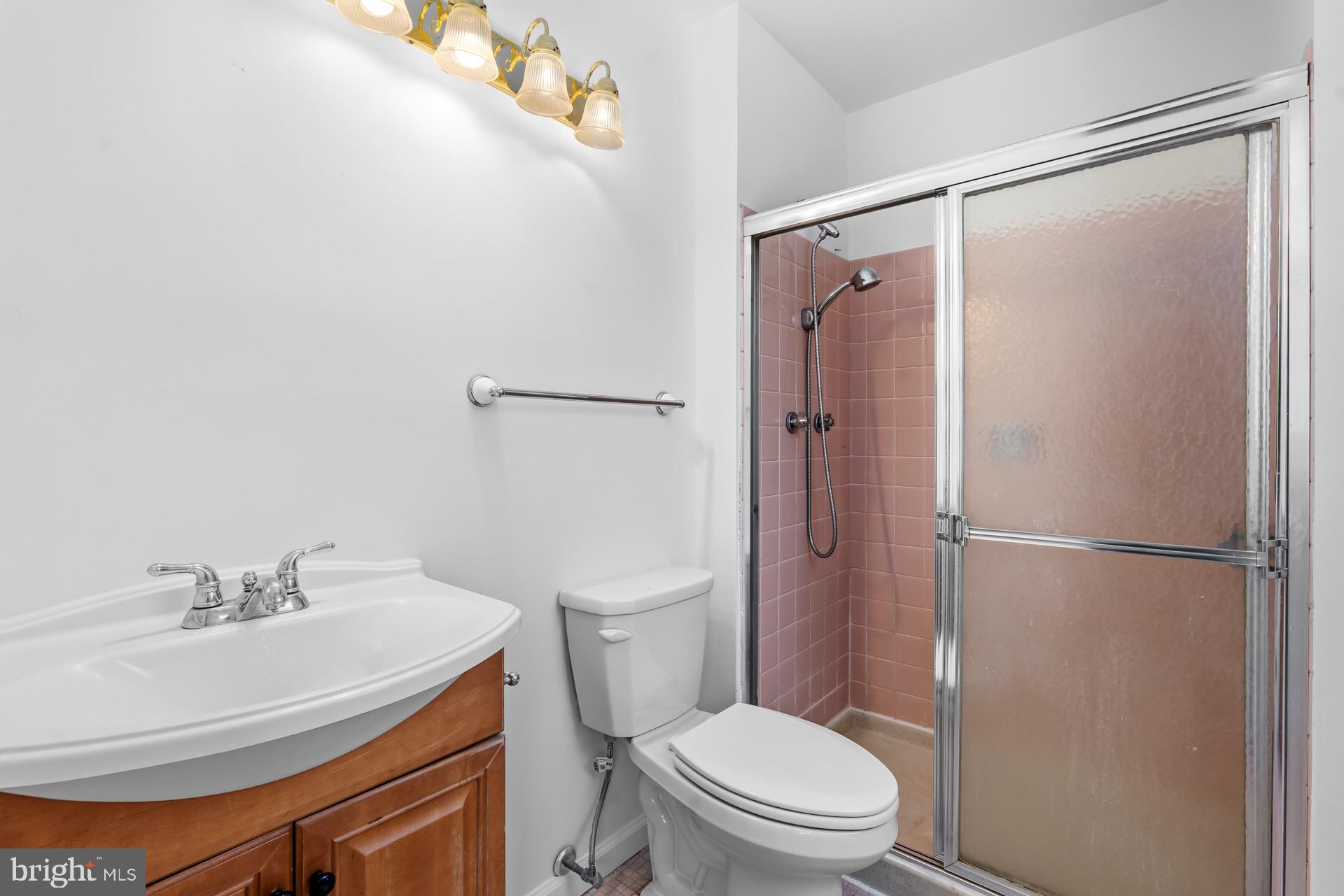 12202 Rustic Hill Drive Bowie, MD 20715 - Photo 18 of 34 a white toilet sitting next to a bathroom sink