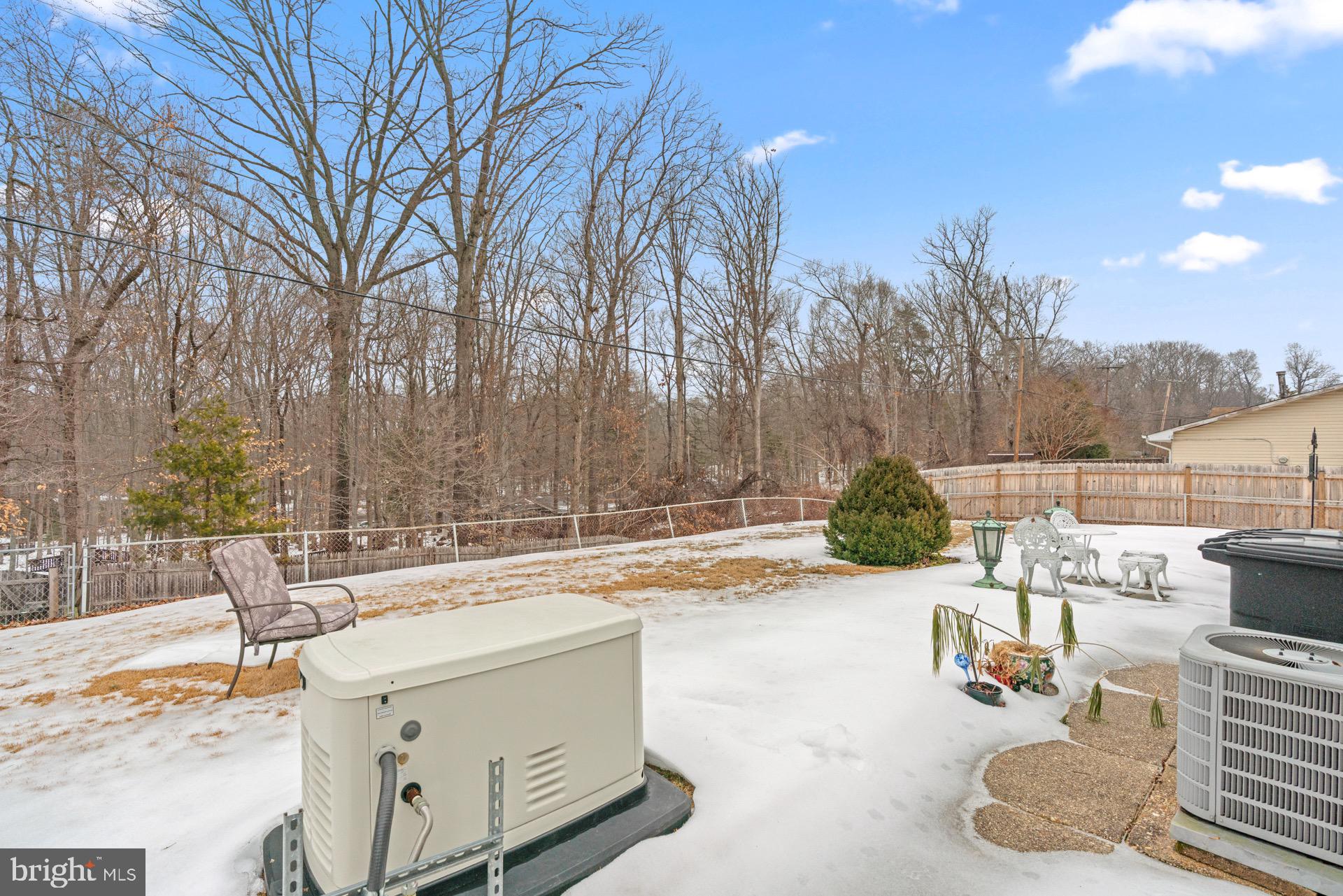12202 Rustic Hill Drive Bowie, MD 20715 - Photo 30 of 34 a view of backyard with swimming pool and outdoor seating