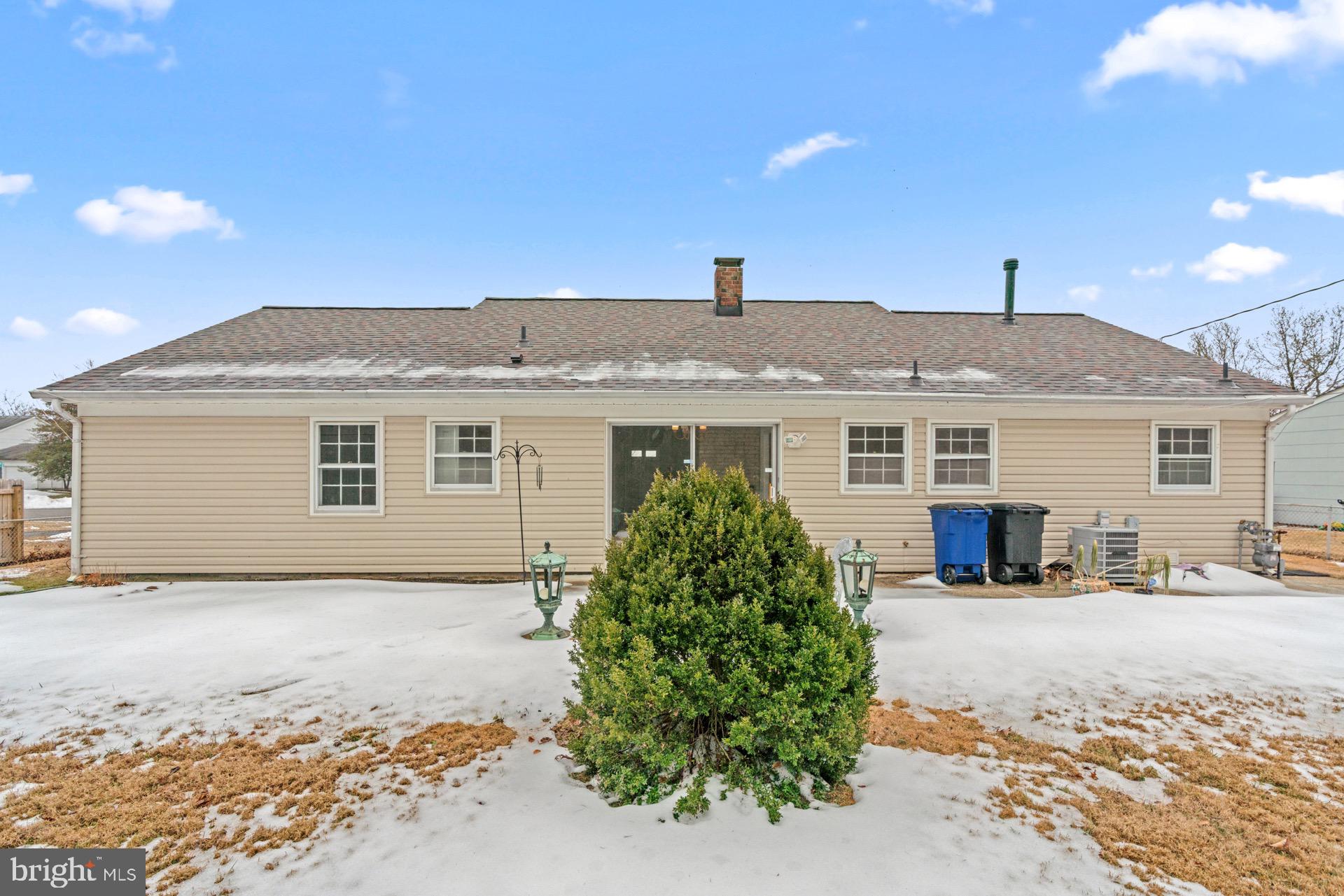12202 Rustic Hill Drive Bowie, MD 20715 - Photo 32 of 34 a front view of a house with a yard and garage