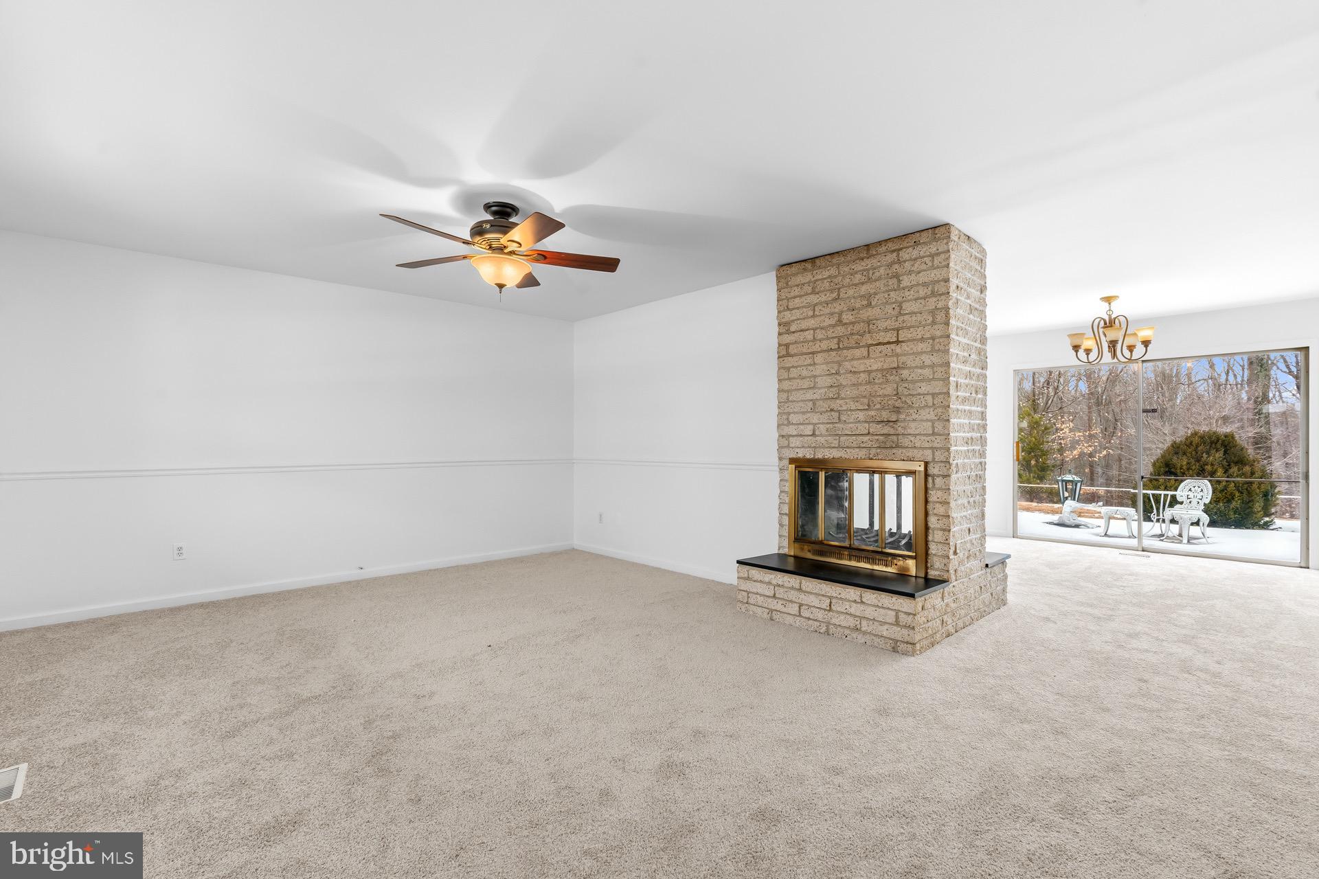 12202 Rustic Hill Drive Bowie, MD 20715 - Photo 4 of 34 an empty room with fireplace and windows
