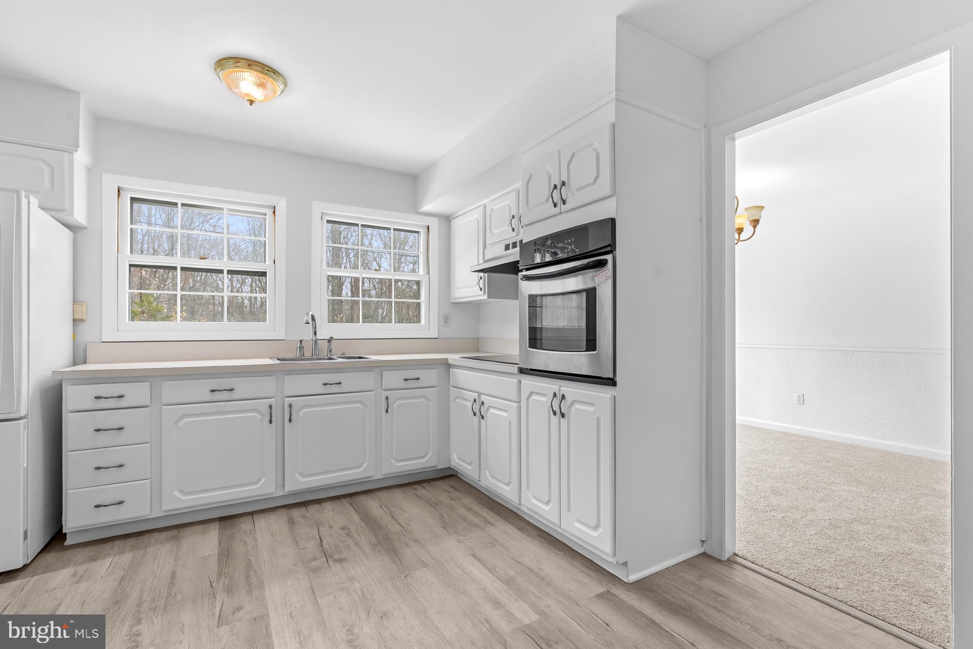 12202 Rustic Hill Drive Bowie, MD 20715 - Photo 10 of 34 a kitchen with granite countertop cabinets stainless steel appliances a sink and a window