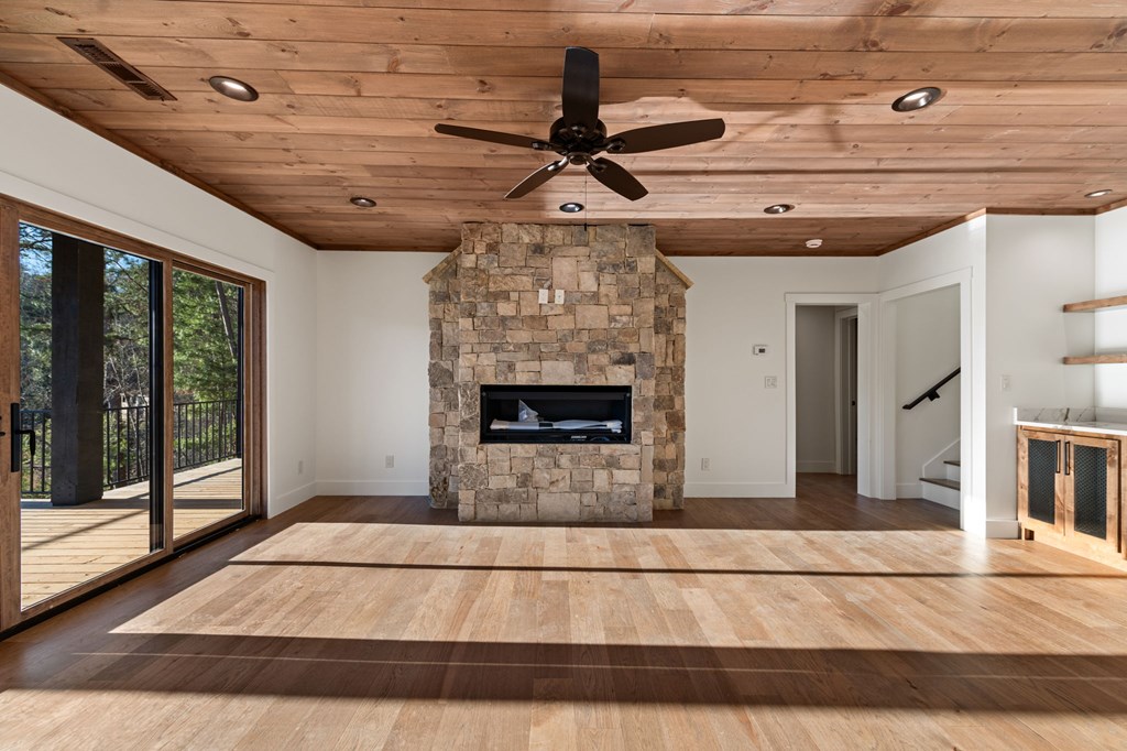 770 Fish Hook Point Blue Ridge, GA 30513 - Photo 58 of 96 2nd Lower Level Living Area, 2nd Lower Level features Full Wet Bar + Stained Ceilings + Gas Fireplace + Storage Behind Bar + Guest Bedroom 2, 3 & 4 + Full Bathroom w/ Walk In Shower | Slider Doors lead to deck & Lake Access