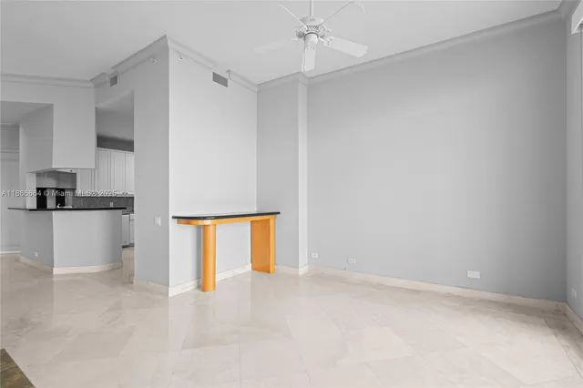 a view of an empty room with cabinet and a window