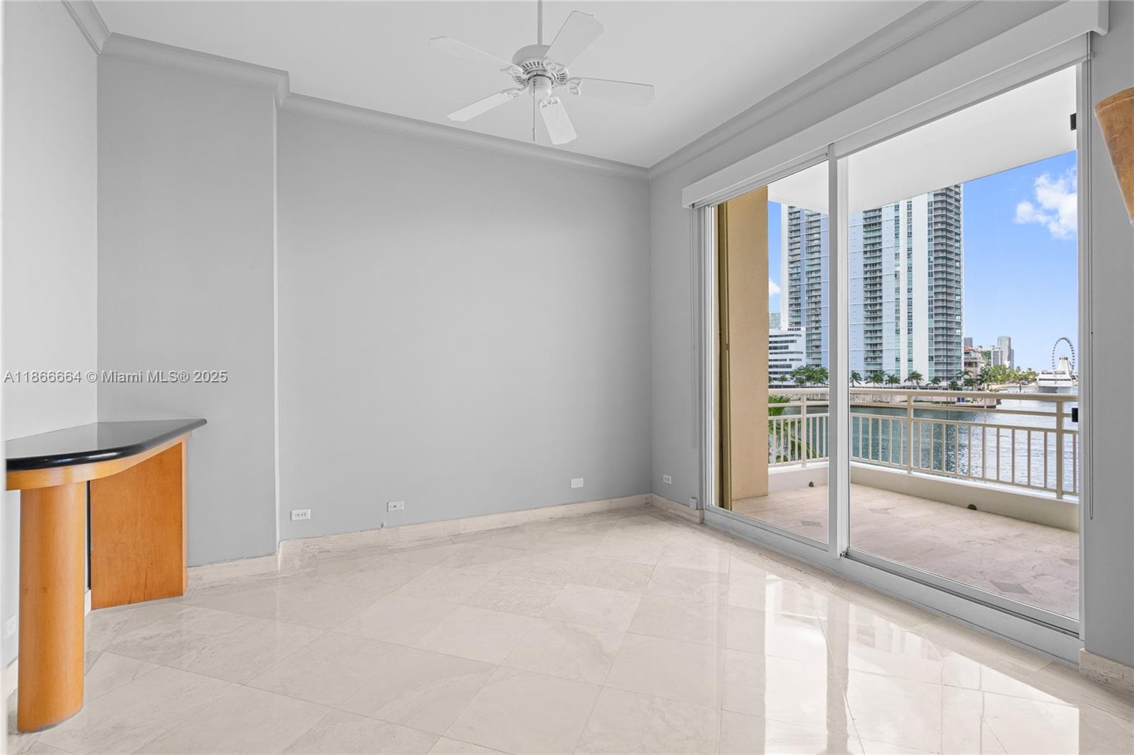 888 Brickell Key Drive, Unit 408 Miami, FL 33131 - Photo 13 of 54 an empty room with fireplace and window
