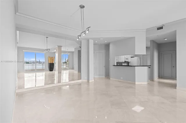 a view of a kitchen with a refrigerator and a sink