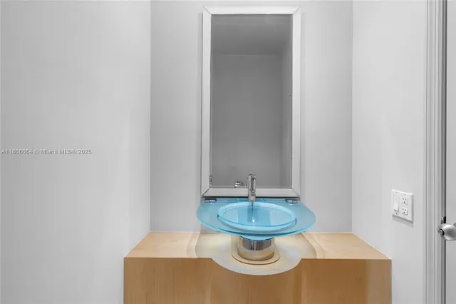 a bathroom with a granite countertop sink mirror and shower