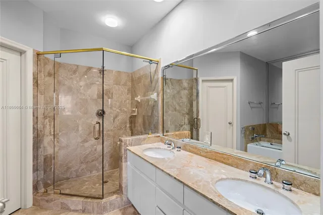 a bathroom with a bathtub and a shower