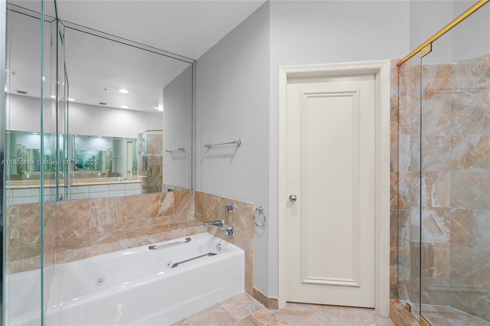 888 Brickell Key Drive, Unit 408 Miami, FL 33131 - Photo 30 of 54 a bathroom with a bathtub and a shower