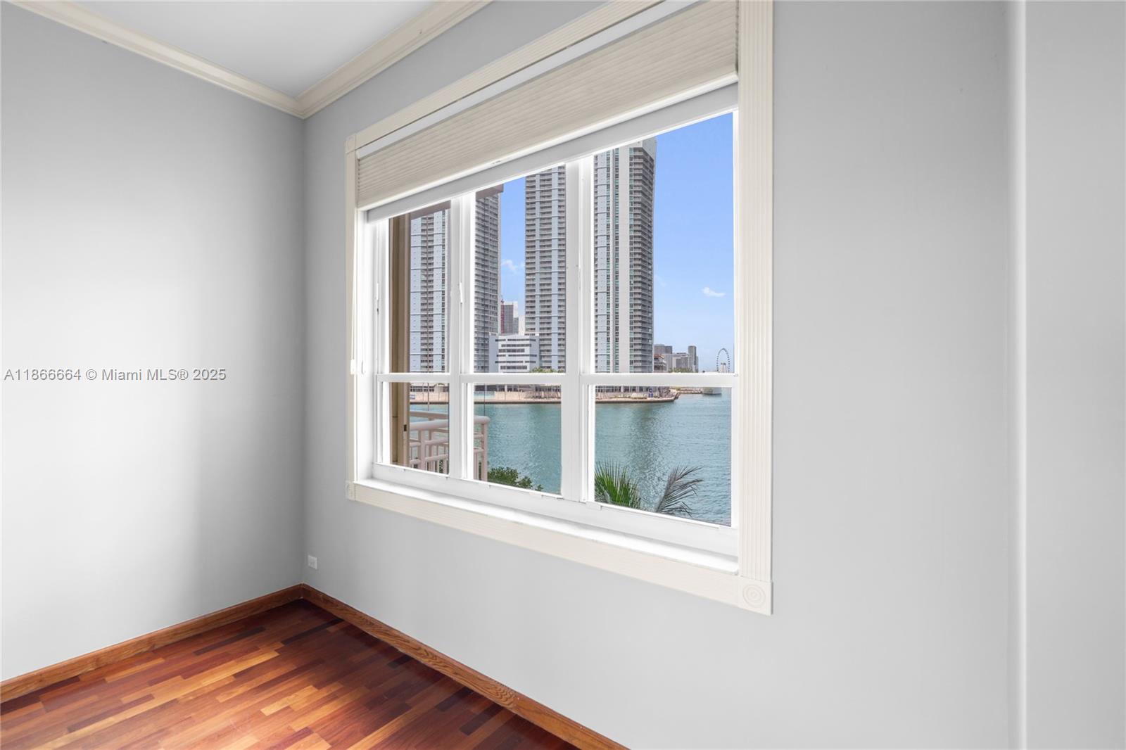 888 Brickell Key Drive, Unit 408 Miami, FL 33131 - Photo 35 of 54 a view of an empty room with wooden floor and a window