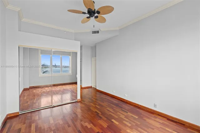 a view of a room that has a bed and a window