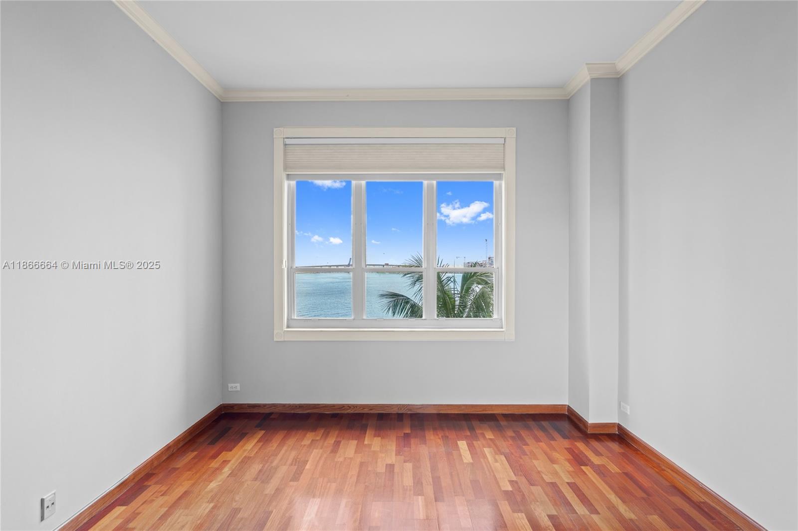 888 Brickell Key Drive, Unit 408 Miami, FL 33131 - Photo 38 of 54 a view of an empty room with wooden floor and a window