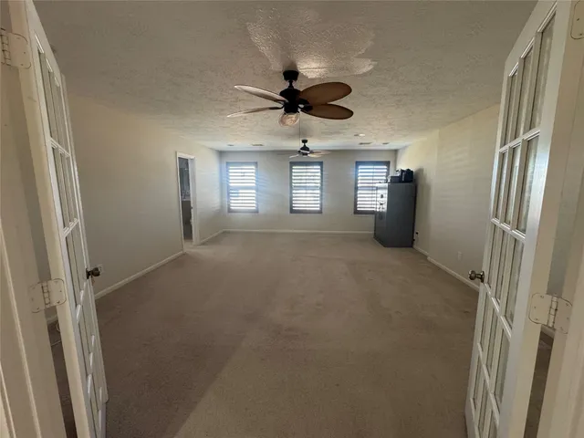 a view of a livingroom with a ceiling fan and window