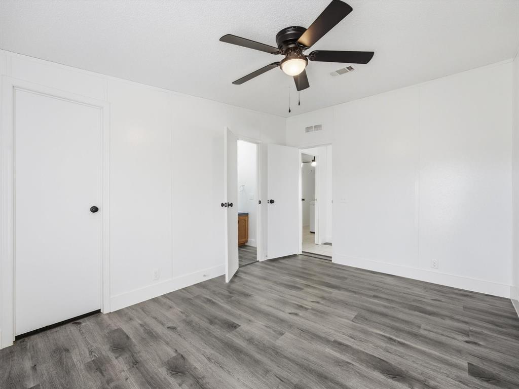 229 Morgan Road Italy, TX 76651 - Photo 24 of 40 an empty room with wooden floor and ceiling fan