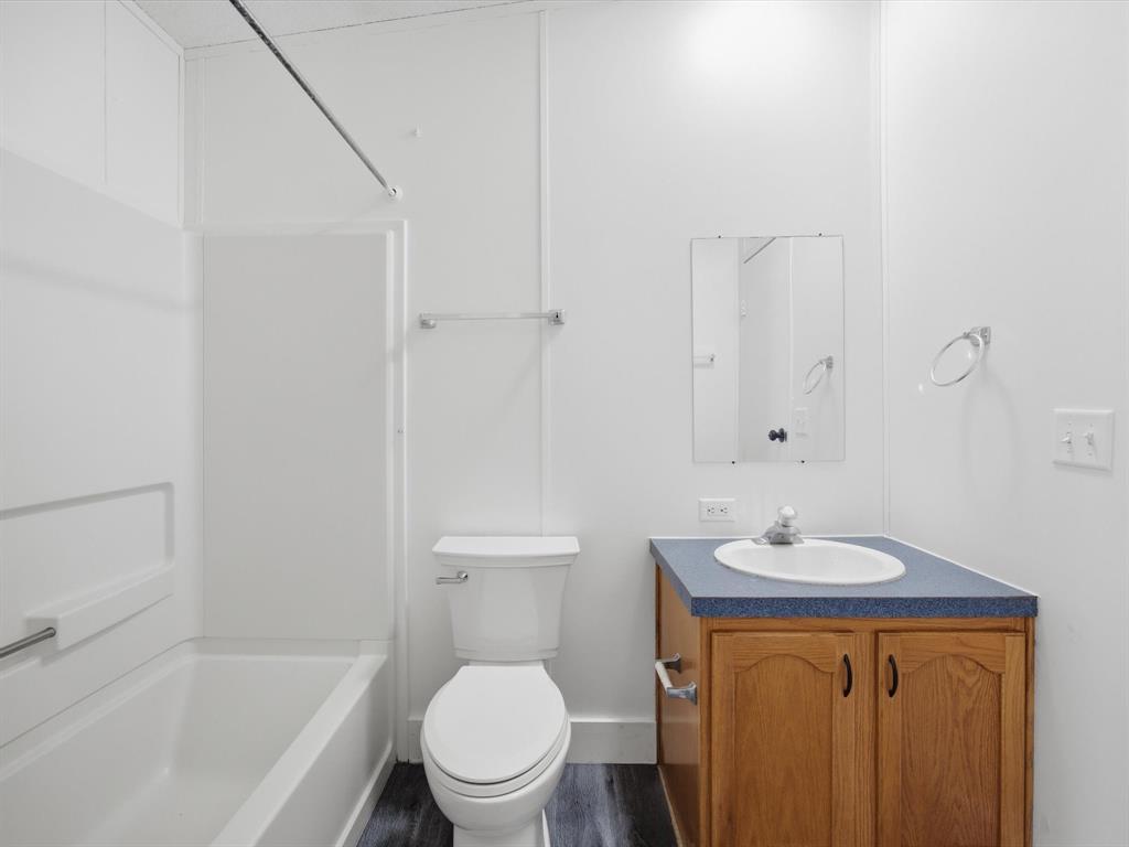 229 Morgan Road Italy, TX 76651 - Photo 25 of 40 a bathroom with a granite countertop sink toilet and shower