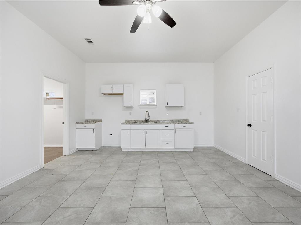 229 Morgan Road Italy, TX 76651 - Photo 32 of 40 a large white kitchen with cabinets