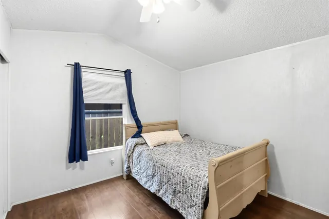 a bed sitting in a bedroom next to a window