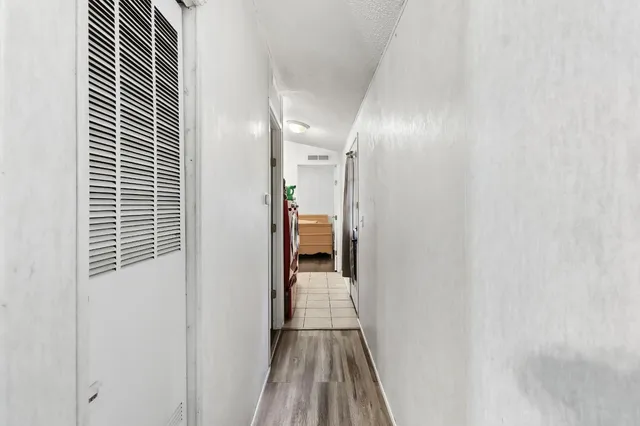 a view of hallway with wooden floor